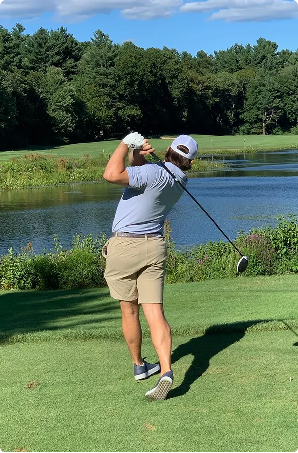 John swinging his golf club